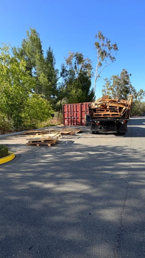 Before â€” Pallet pile cleared from a commercial lot